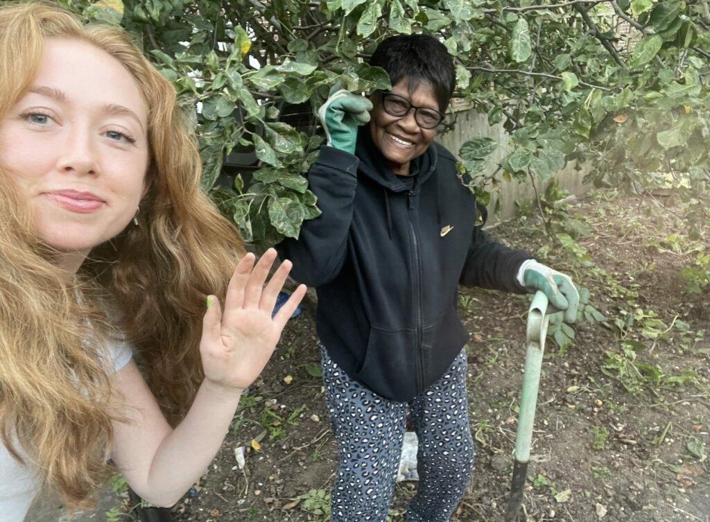 Two people waving and smiling. Top 10 Hackney volunteering roles in March 2025